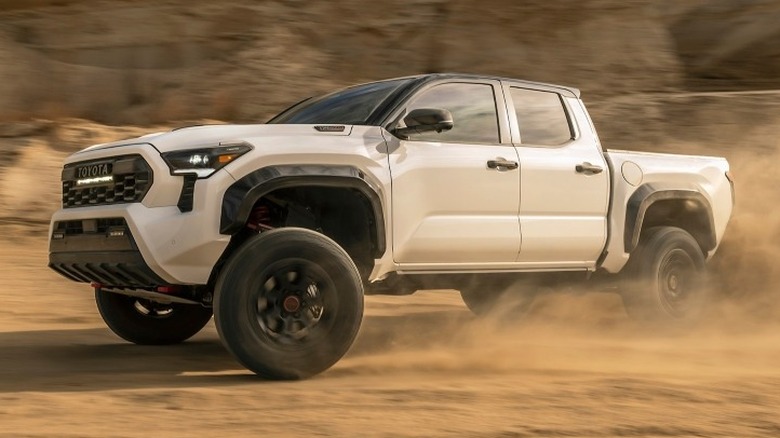 Front 3/4 shot of a Toyota TRD Pro driving on sand