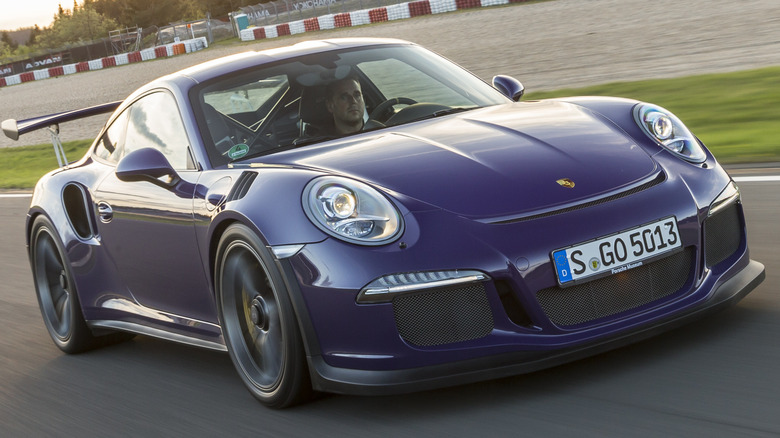 A blue Porsche 911 GT3 RS (Type 991) on a racetrack.