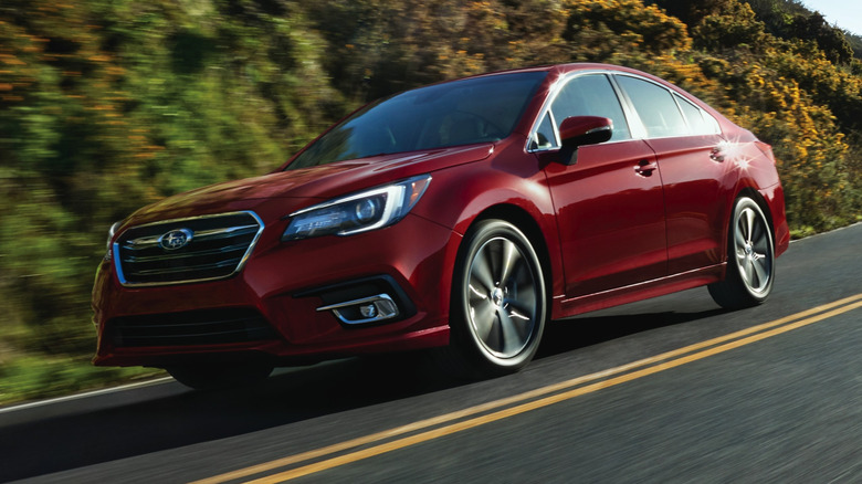 Red 2018 Subaru Legacy on the road