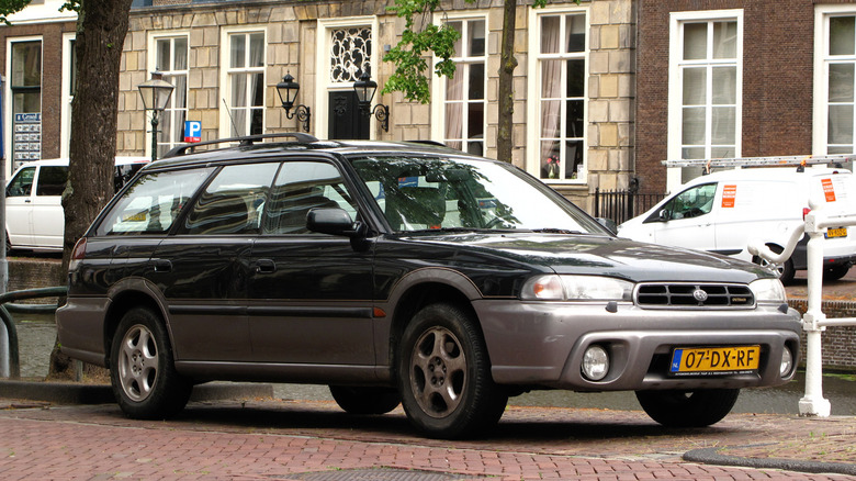 Dark green 2000 Subaru Legacy Outback parked