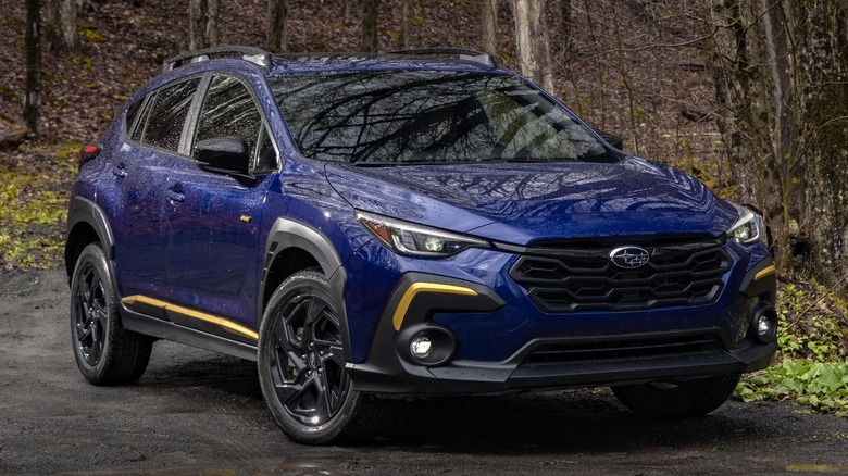 Blue 2024 Subaru Crosstrek Sport parked in the rain