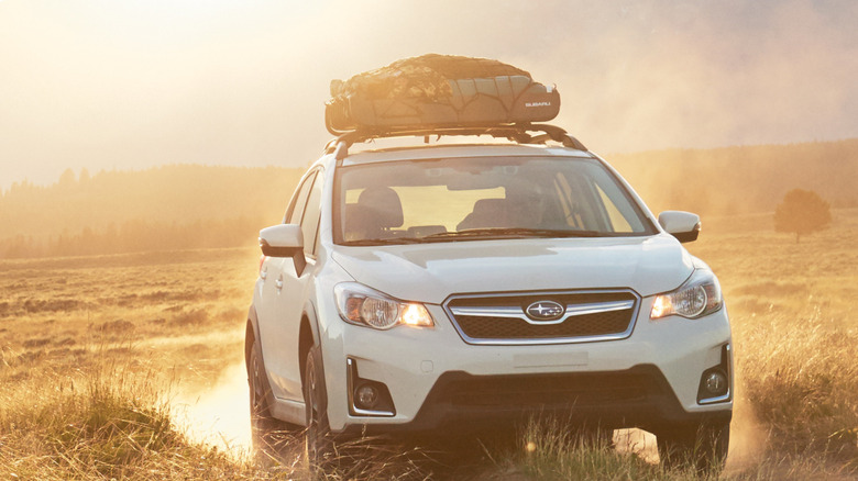 White 2017 Subaru Crosstrek driving on dirt