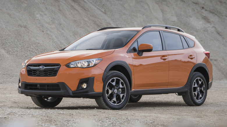 Orange 2020 Subaru Crosstrek parked on dirt