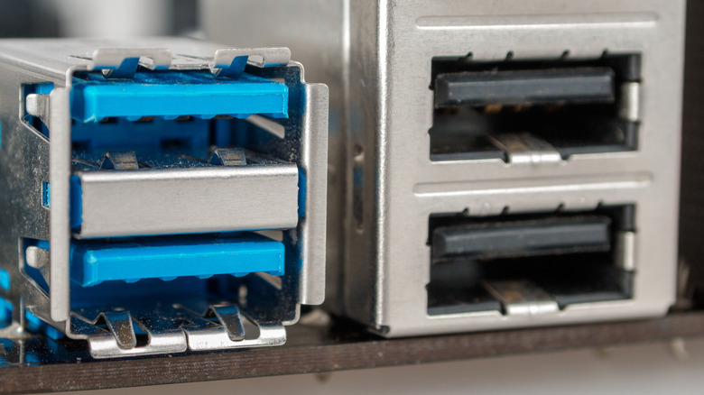 blue-colored USB 3.0 ports to the left of black/gray USB 2.0 ports on a PC motherboard