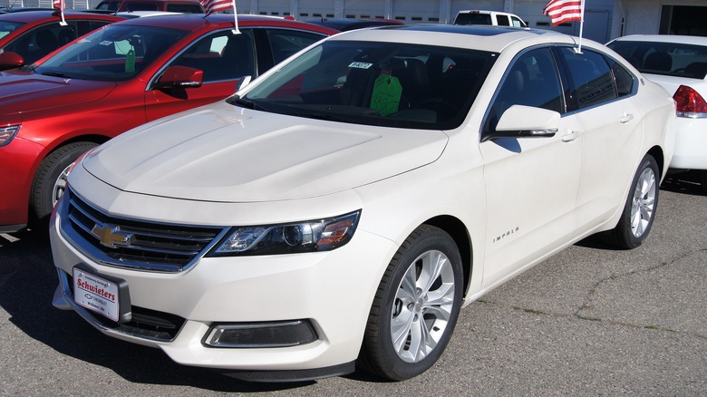 White 2014 Chevrolet Impala parked on dealer forecourt