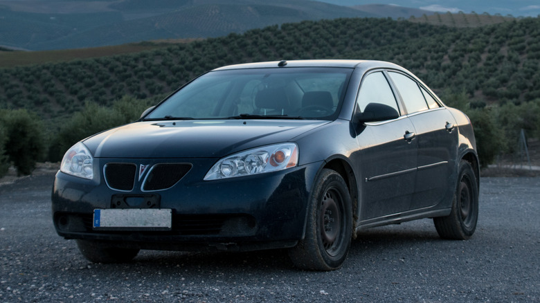 Black 2008 Pontiac G6 parked on gravel