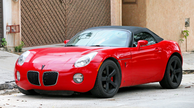 Red Pontiac Solstice parked on street