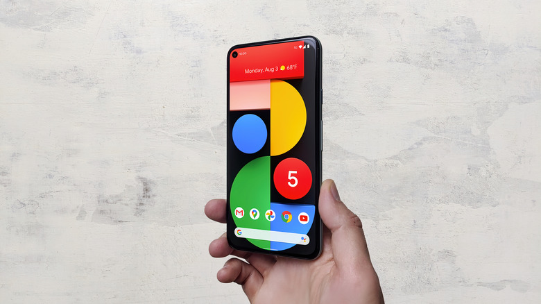man holding Google Pixel 5 5G smartphone