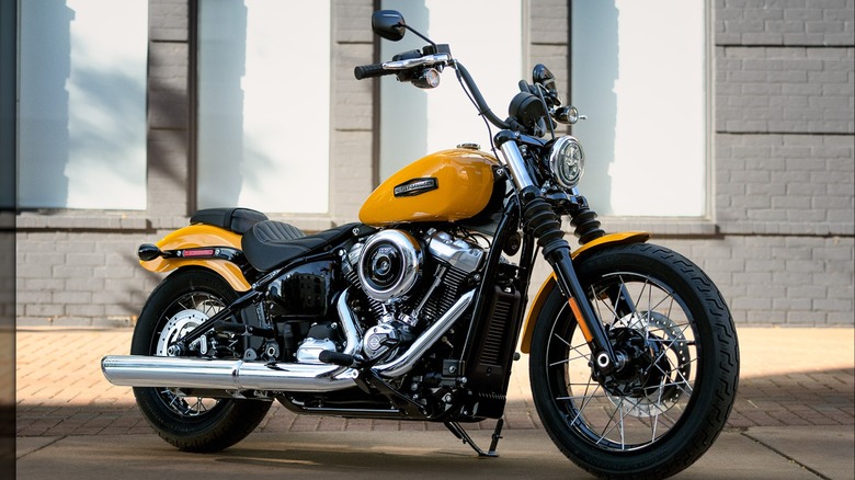 Yellow 2025 Harley-Davidson Street Bob parked on sidewalk