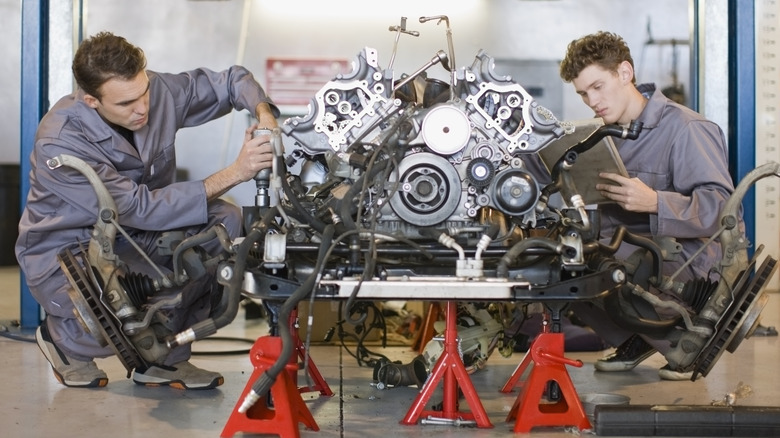 Two men working on engine