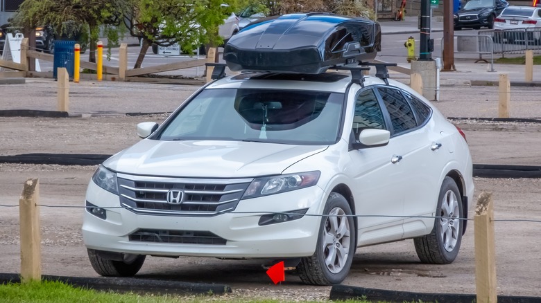 A white Honda Accord Crosstour with a roofbox, front 3/4 view