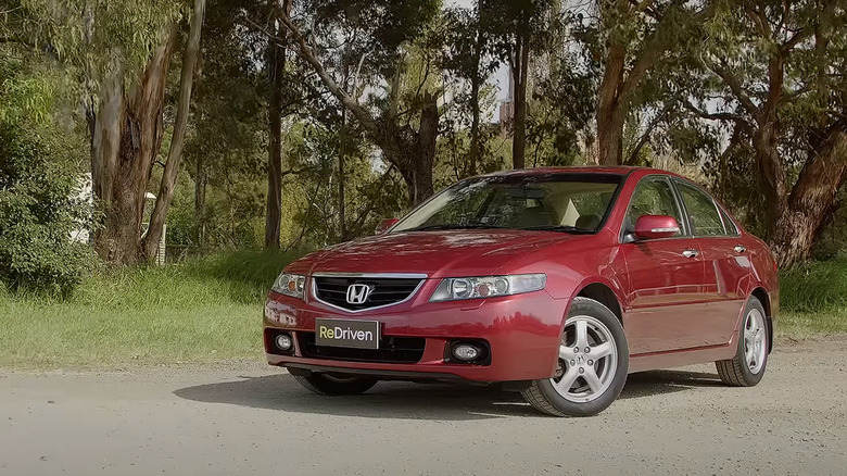 Red Honda Accord Euro parked on a road