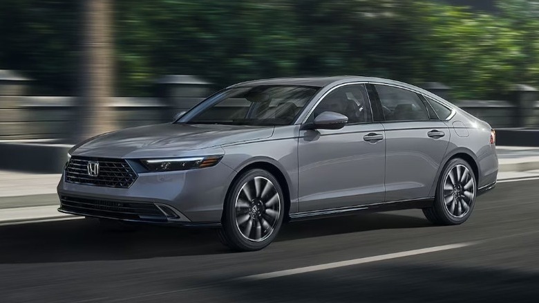 2025 Honda Accord Touring Hybrid driving with trees in the background