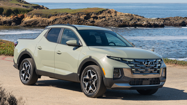 The Hyundai Santa Cruz in bright olive green, front 3/4 view