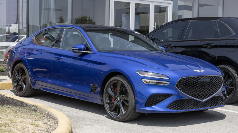 A Genesis G70 facelift in blue, front 3/4 view