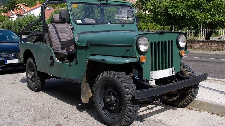 Green Jeep CJ-6 parked at roadside