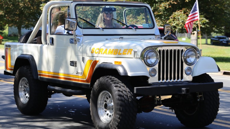 White Jeep CJ-8 Scrambler in motion