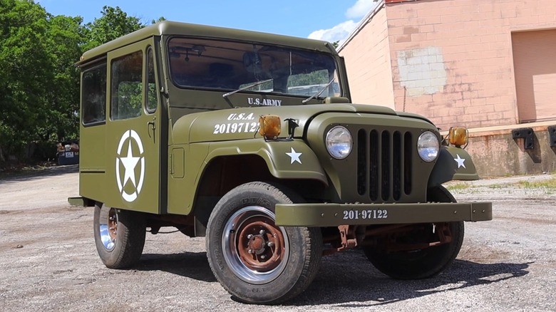 U.S. Army Jeep DJ-5 parked in front of a building