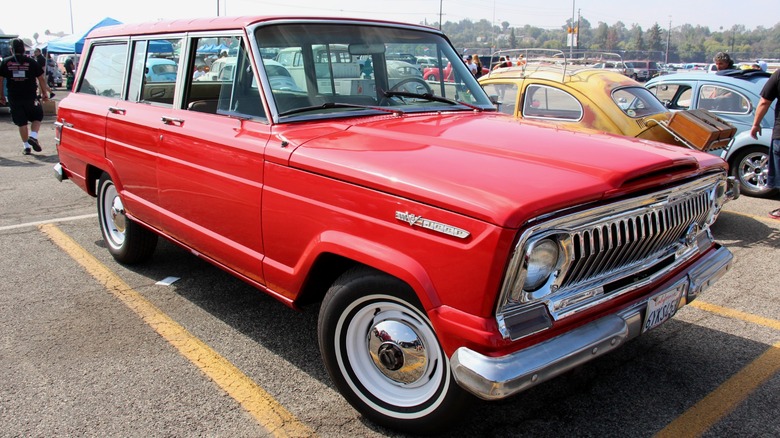 Red Jeep Wagoneer SJ parked at a car show