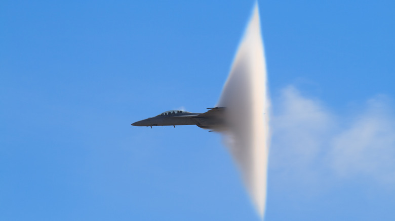 F/A-18 Super Hornet surrounded by vapor after breaking the sound barrier