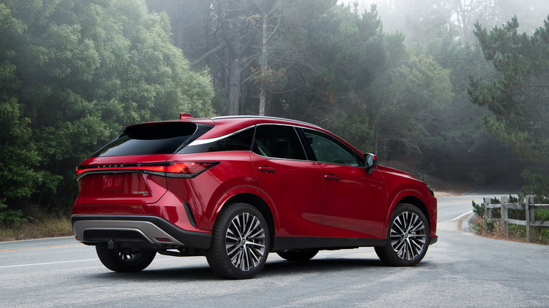 2024 Lexus RX Hybrid parked on a road with woods and mist in the background