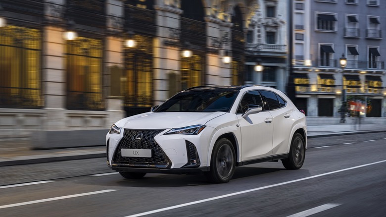 2025 Lexus UX 300h F Sport driving at speed in urban environment