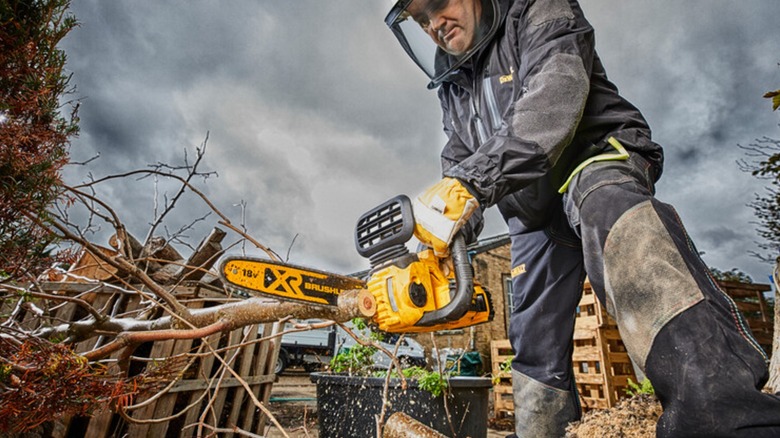 cutting branches with DeWalt chainsaw