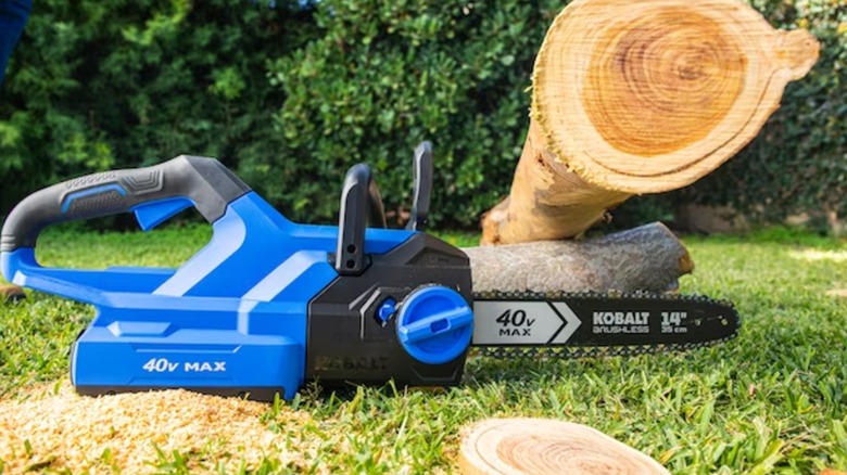 A Kobalt chainsaw in front of log