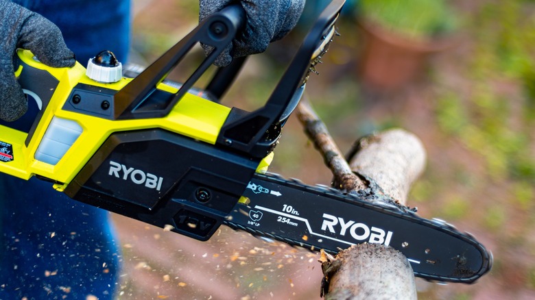 a Ryobi chainsaw cutting log