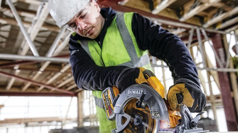 A man using a DeWalt circular saw