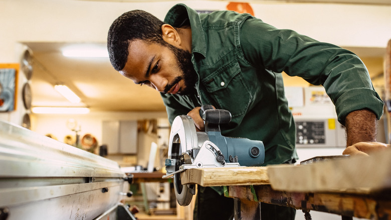 Man using circular saw in workshop