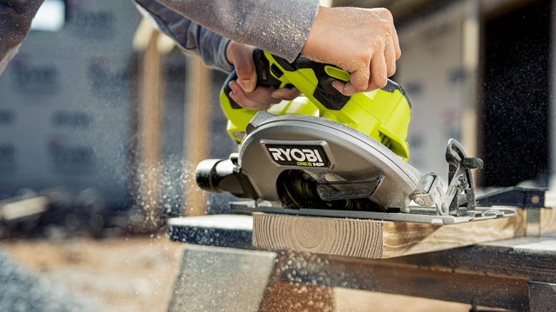 Man using a Ryobi circular saw on wood