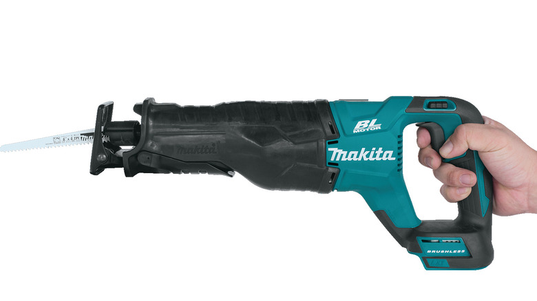 Hand holding a Makita cordless reciprocating saw