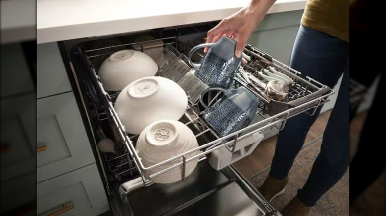 a Whirlpool dishwasher being loaded