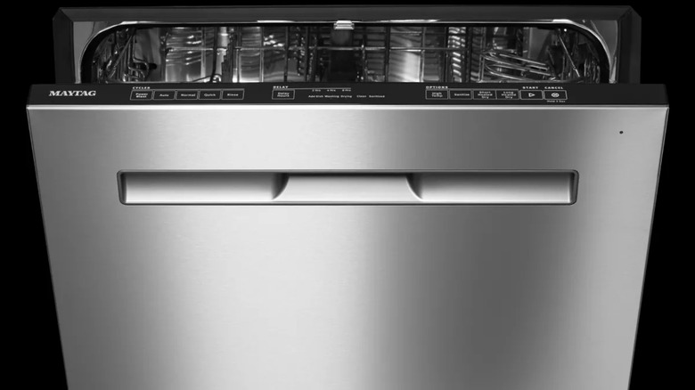 Closeup of Maytag stainless steel dishwasher with black background