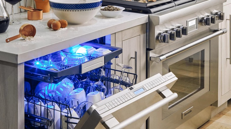 Thermador dishwasher glowing blue next to stove