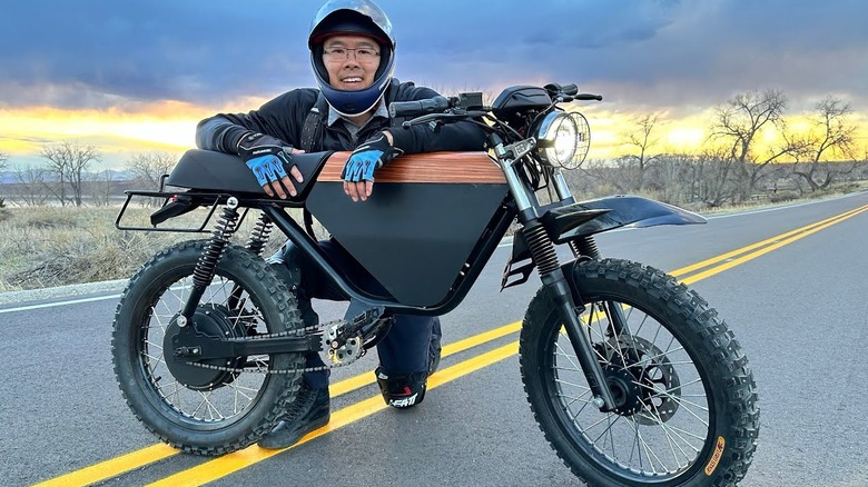 Person kneeling behind an Onyx motorbike