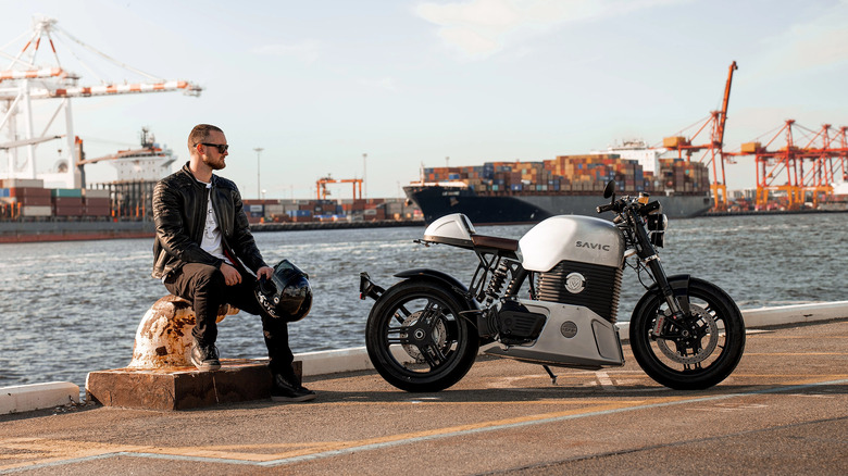 Person sitting near a Savic motorcylce