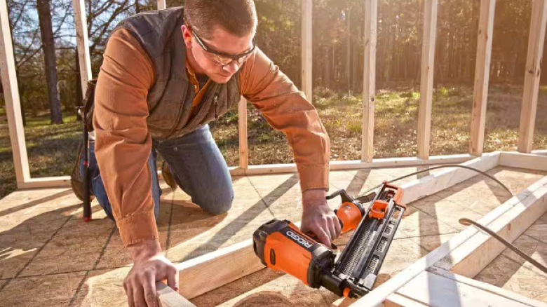 Man using Ridgid nailer on lumber