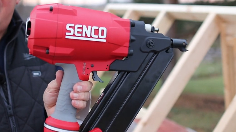 Person holding Senco framing nailer