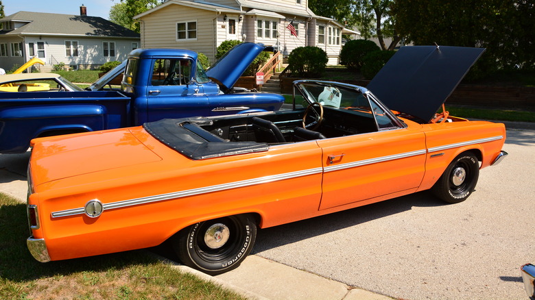 An orange 1966 Plymouth Belvedere parked in a driveway