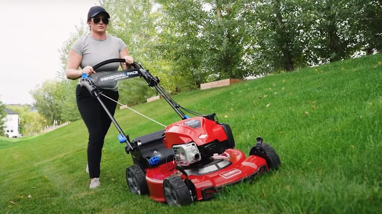 Woman mowing with Toro Mower