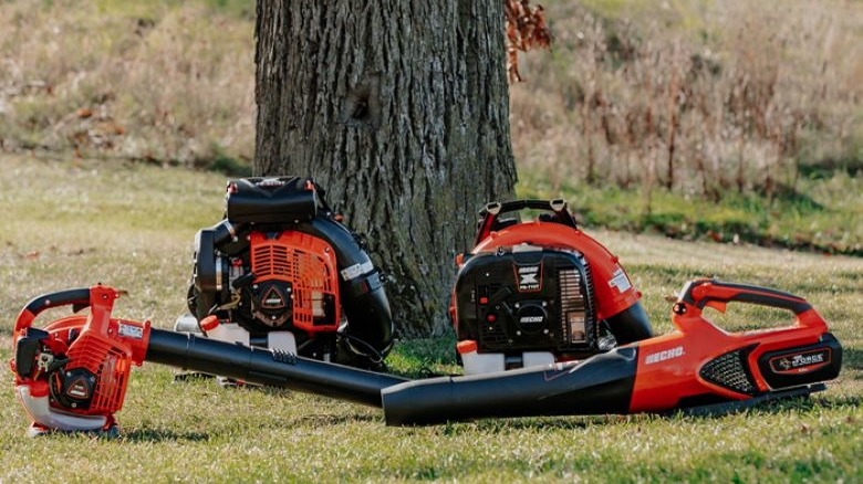 Several Echo leaf blowers near a tree