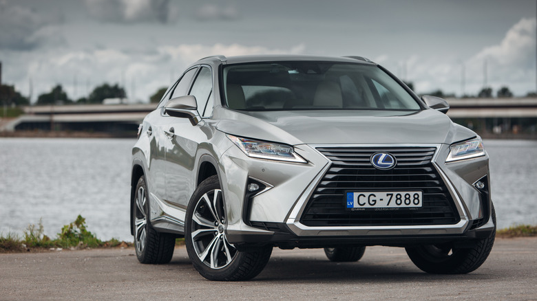 Silver Lexus RX 450 hybrid by river