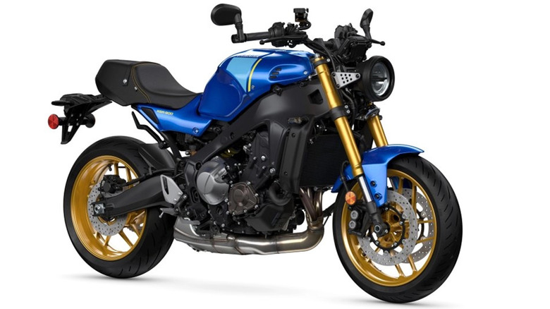 A blue 2023 Yamaha XSR900 with gold wheels