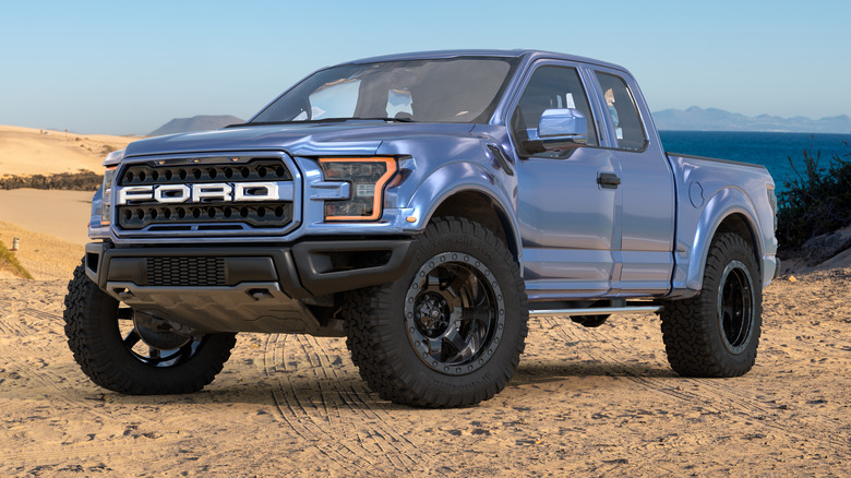 A blue Ford F-150 parked near a lake