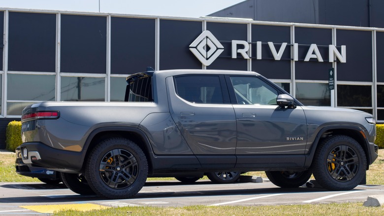 A gray Rivian truck parked in front of Rivian HQ