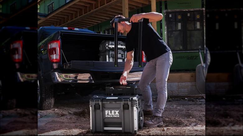 Man loading Flex toolbox into truck bed