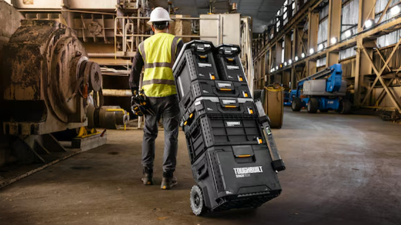 Man pulling Toughbuilt boxes in warehouse