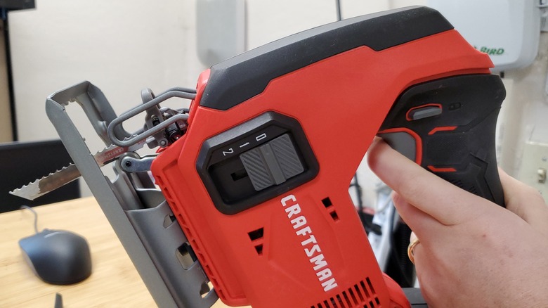 carpenter using a drill on a piece of wood